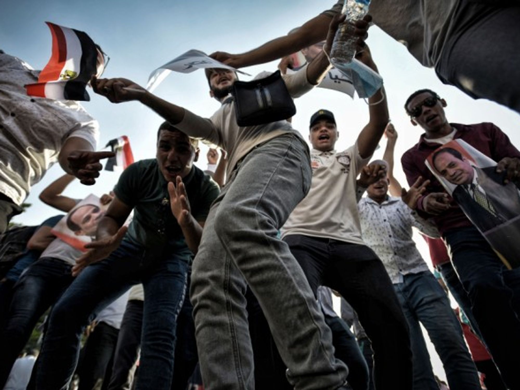 Supporters of Egyptian President Abdel Fattah al-Sisi dance and wave flags during a pro-government rally