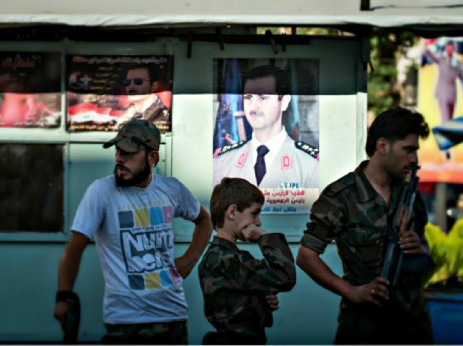 Syrian Army soldiers at a chekpoint in Damascus in June
