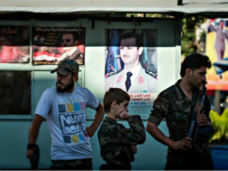 Syrian Army soldiers at a chekpoint in Damascus in June