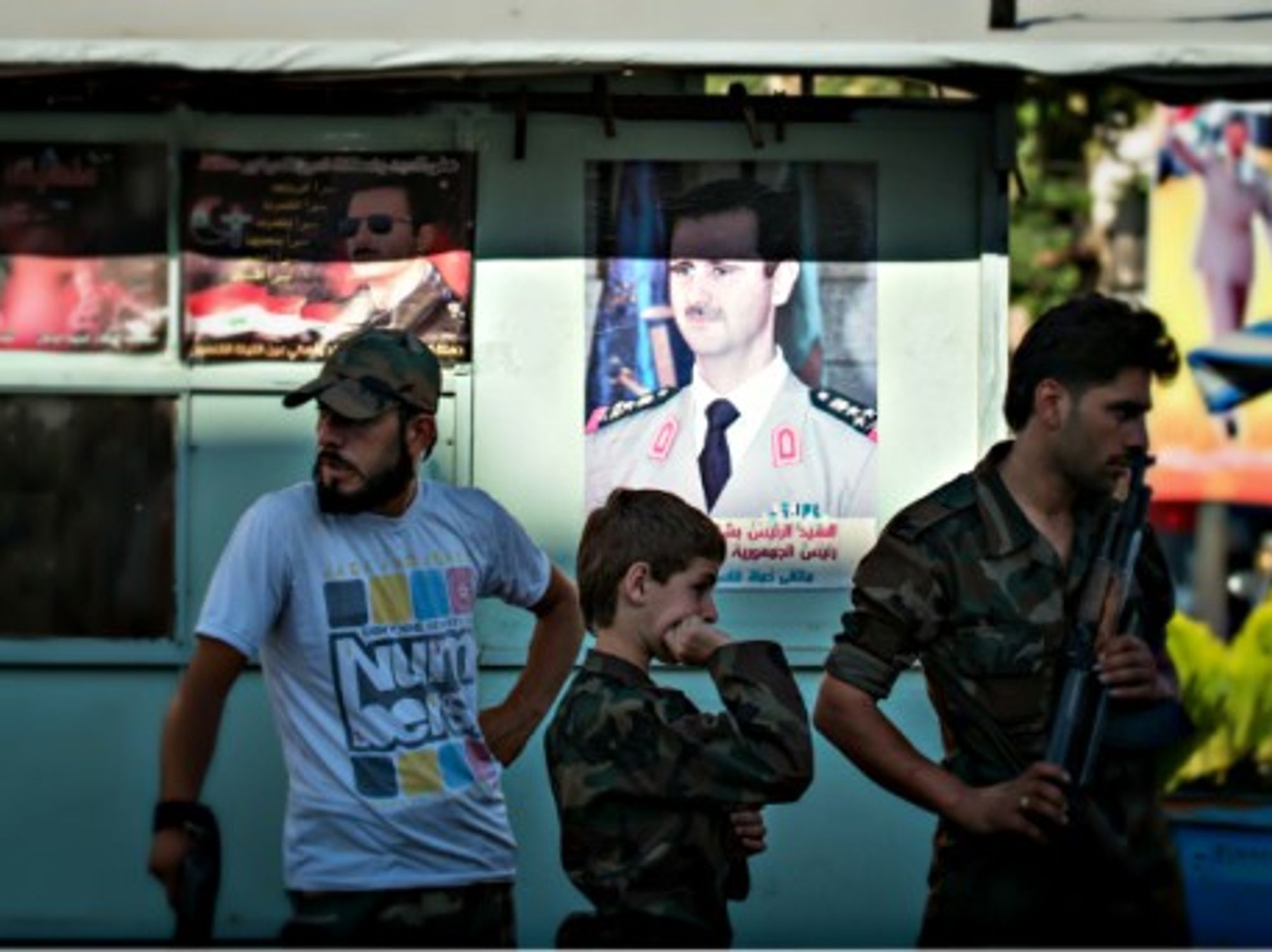 Syrian Army soldiers at a chekpoint in Damascus in June