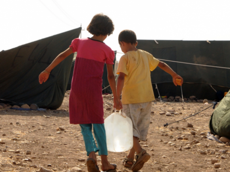 Syrian children fetch water at Kawergost Refugee Camp, some 50 km north of Erbil, capital of Iraq's autonomous Kurdish region.