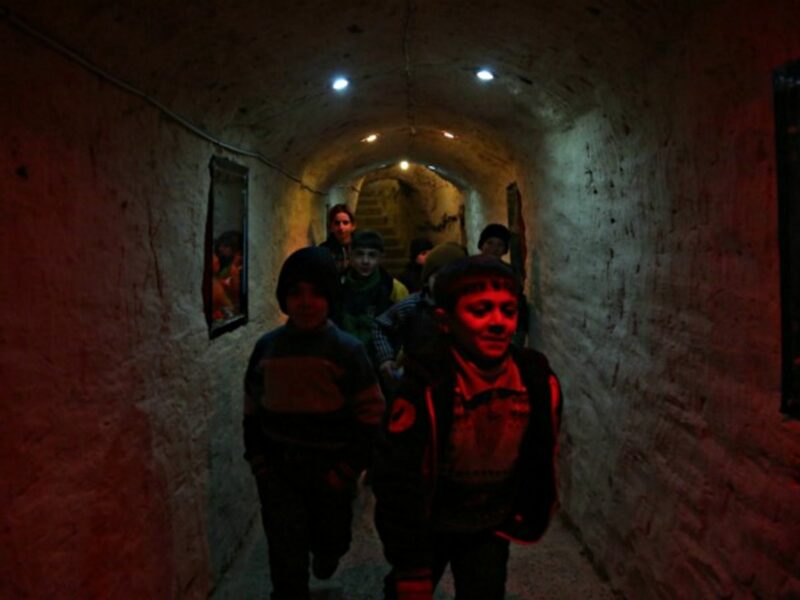 Syrian children that live in underground to escape the threat of airstrikes and mortar attacks.