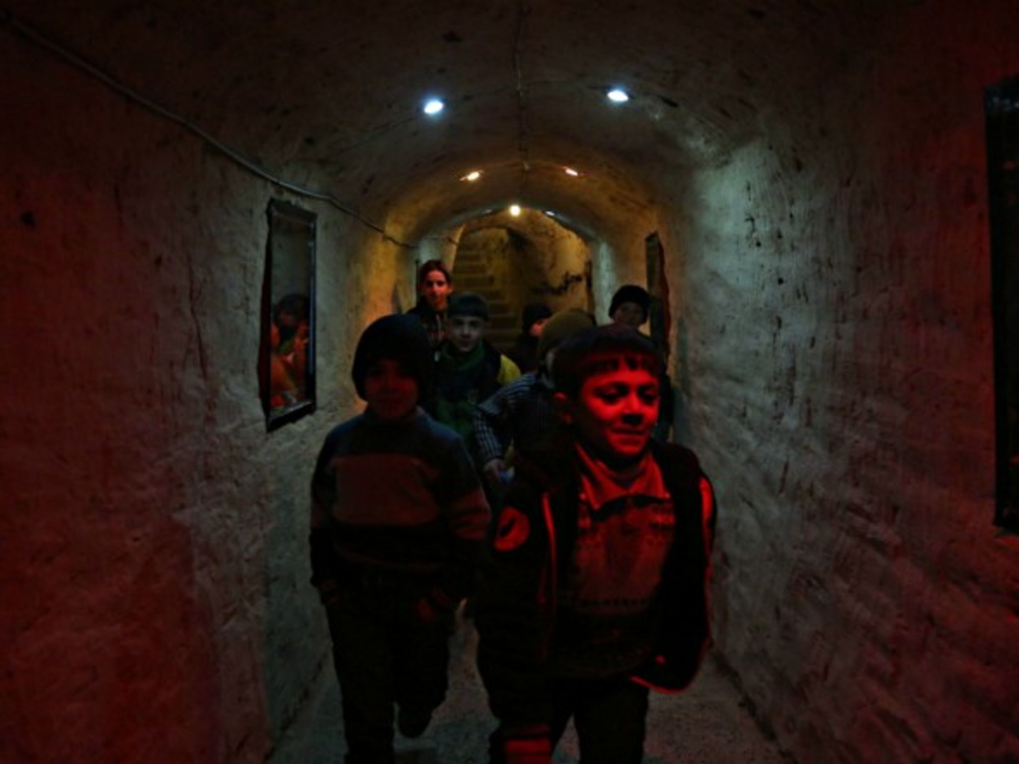 Syrian children that live in underground to escape the threat of airstrikes and mortar attacks.