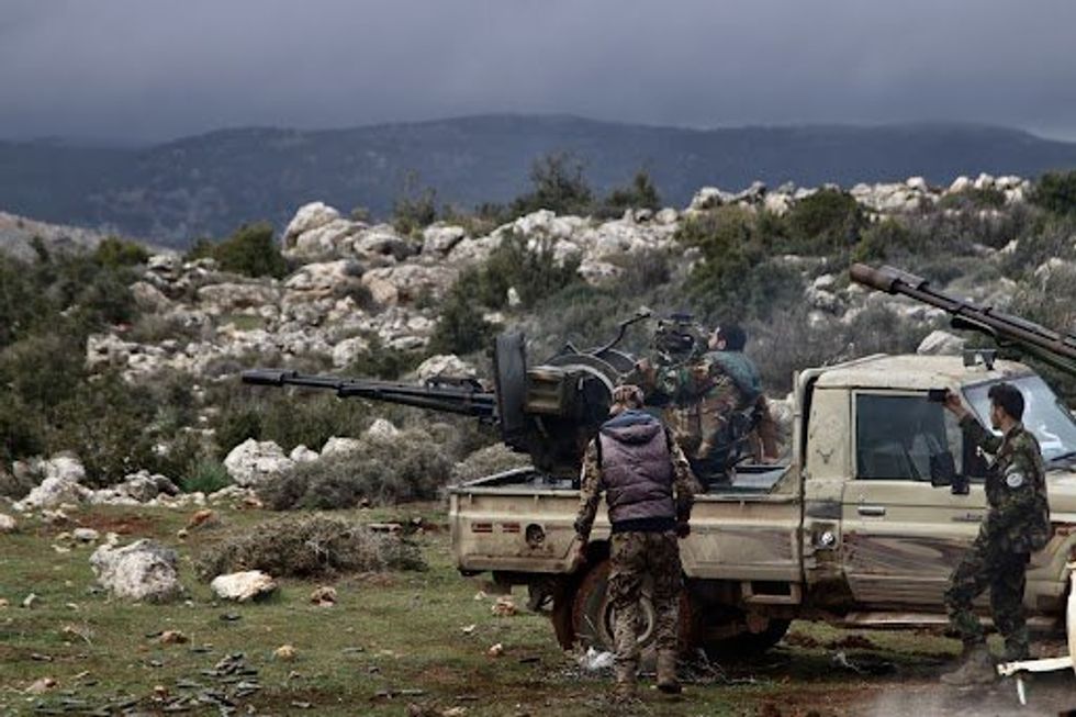 Syrian fighters are seen during an operation in the village of Hawik, central province of Homs.
