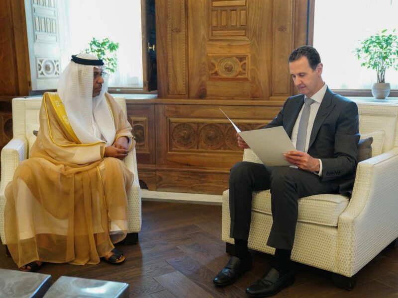 Syrian President Bashar al-Assad sits across from Sheikh Mohammed bin Zayed