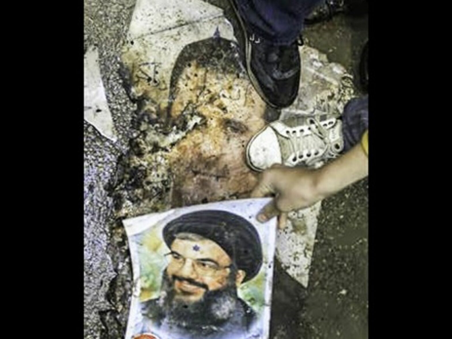 Syrian protesters step on posters of Bashar al-Assad and Hezbollah leader Hassan Nasrallah in January 2012 (FreedomHouse2)