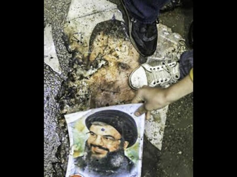 Syrian protesters step on posters of Bashar al-Assad and Hezbollah leader Hassan Nasrallah in January 2012 (FreedomHouse2)