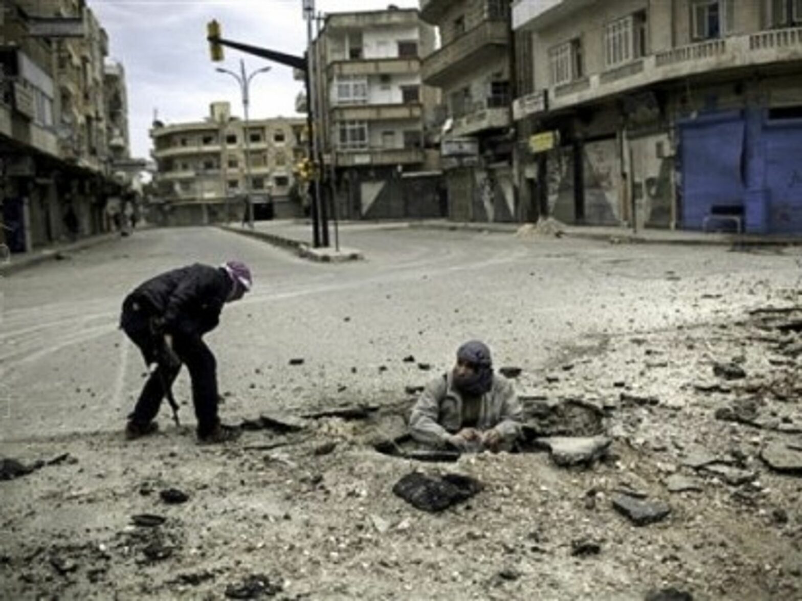 Syrian rebel fighters, short on weapons, plant a bomb to target a government tank (Freedom House2)