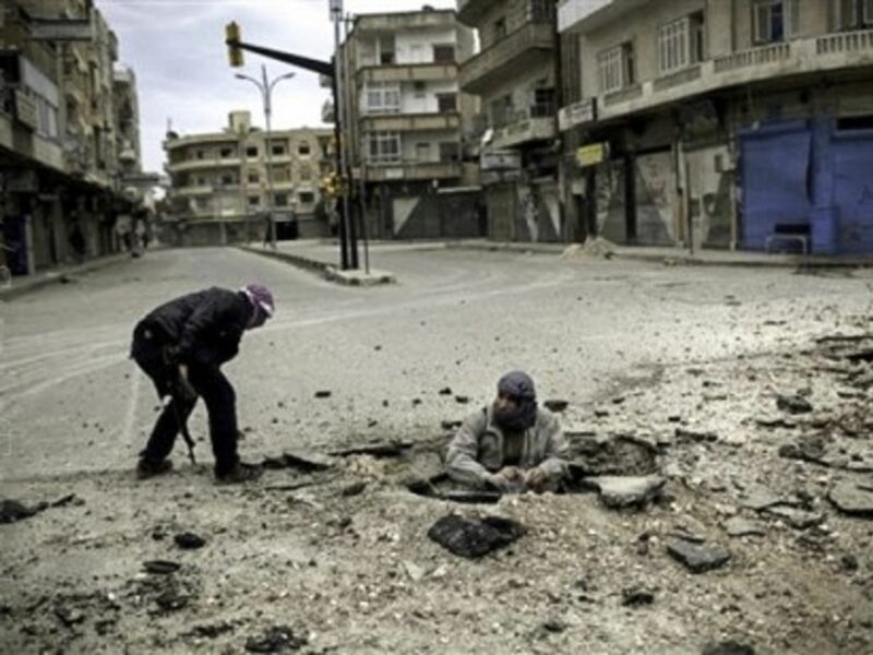 Syrian rebel fighters, short on weapons, plant a bomb to target a government tank (Freedom House2)