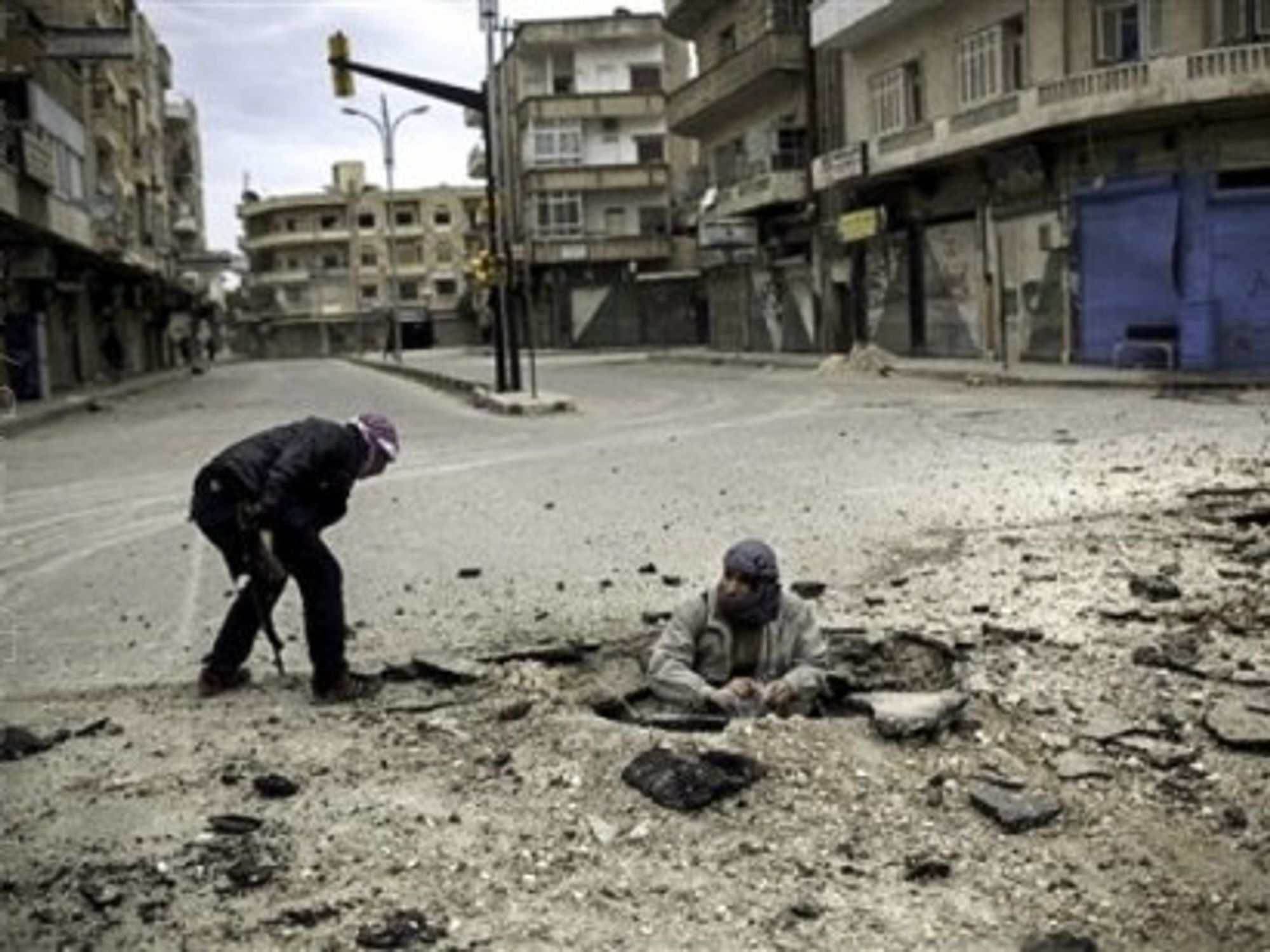 Syrian rebel fighters, short on weapons, plant a bomb to target a government tank (Freedom House2)
