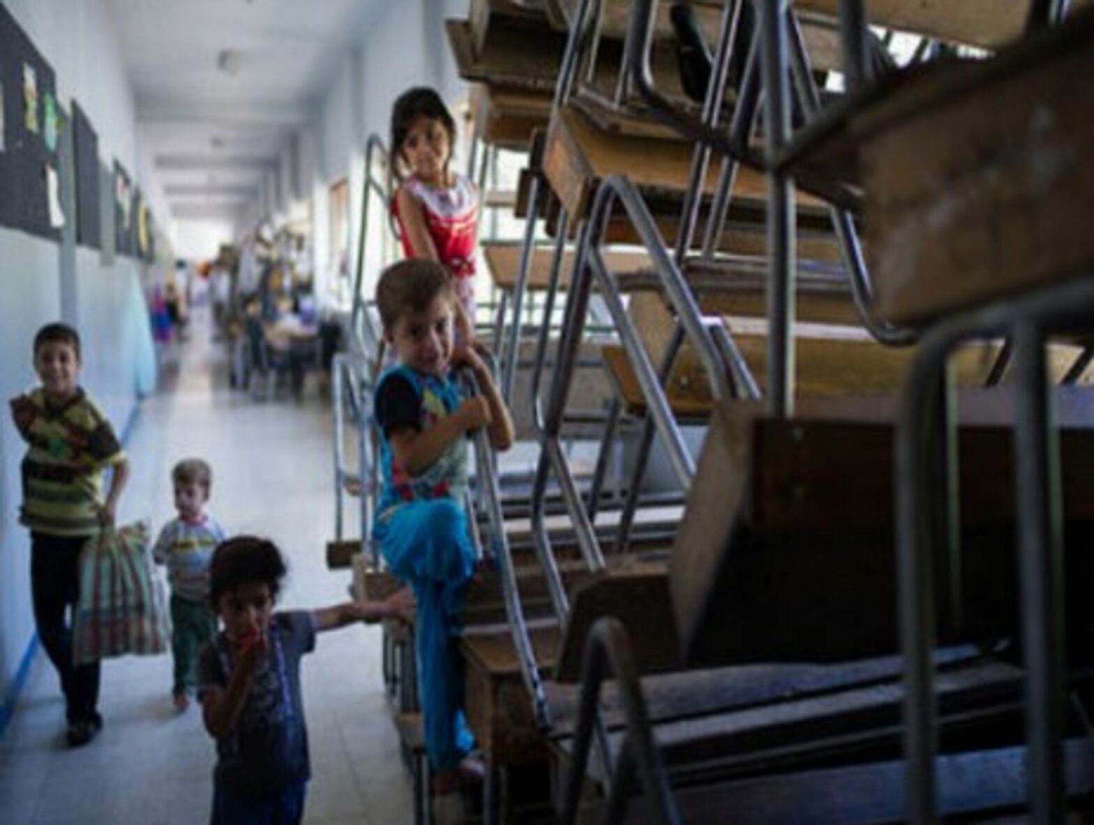 Syrian refugee children play at a school in Damascus on August 23, 2012.