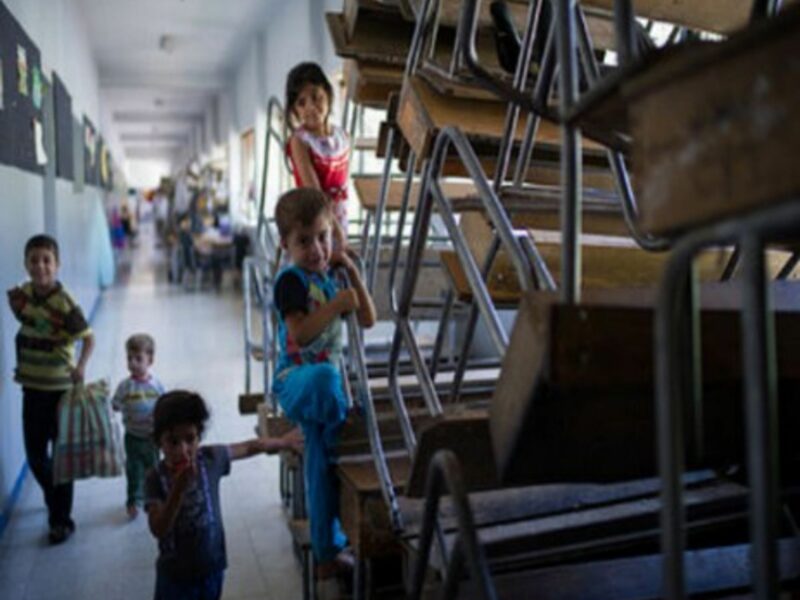 Syrian refugee children play at a school in Damascus on August 23, 2012.
