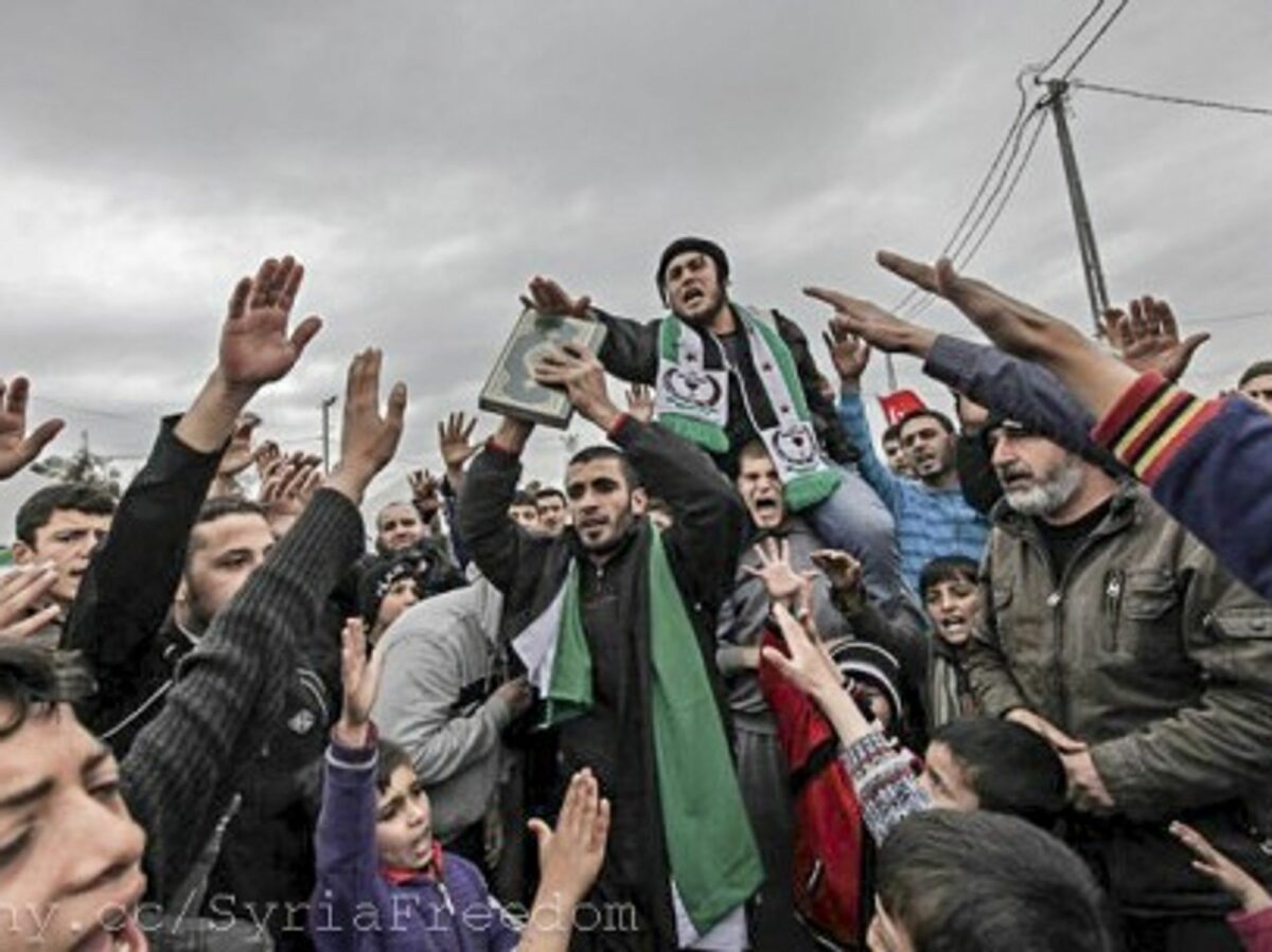 Syrian refugees center around a Koran
