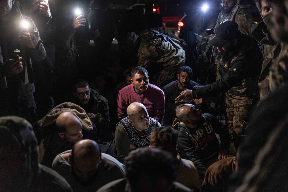Syrian regime fighters captured by Syrian armed opposition forces in Aleppo as opposition fighters seize control of most parts of Aleppo.