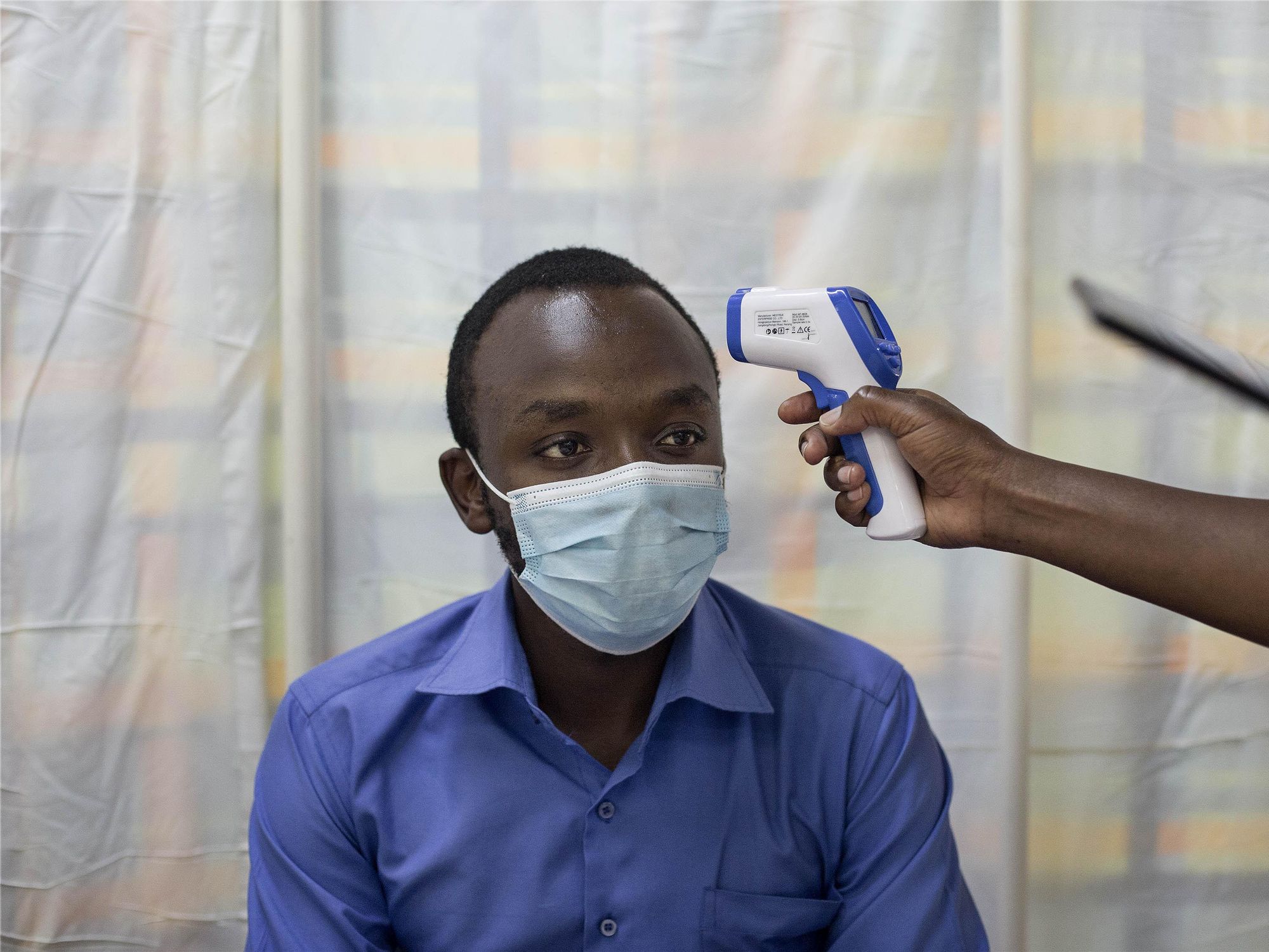 Taking the temperature of a Kenyatta National Hospital staff member in Nairobi