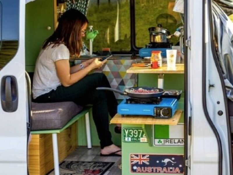 The author having dinner inside her camper van.