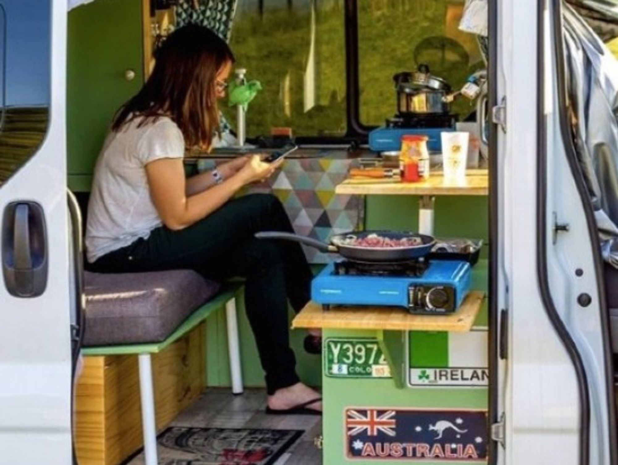 The author having dinner inside her camper van.