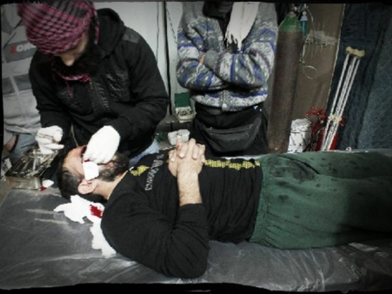 The dark, damp emergency room in the field hospital of besieged Homs