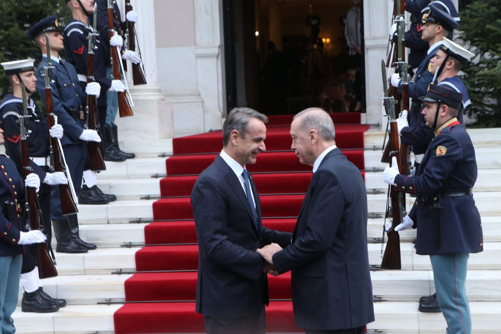 The Greek Prime Minister greets the Turkish President on the steps of the Maximos Mansion
