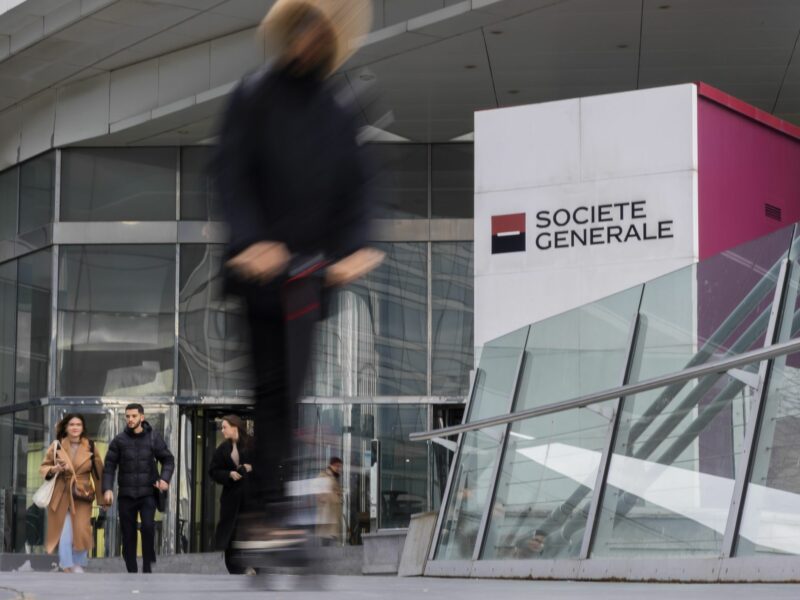The headquarters for Societe General in Paris has people walking out of the big office building