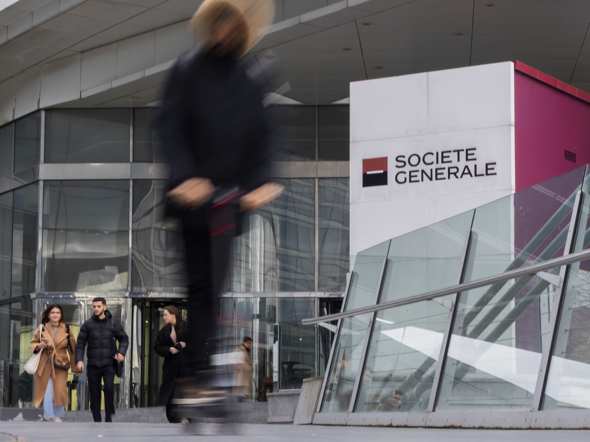The headquarters for Societe General in Paris has people walking out of the big office building