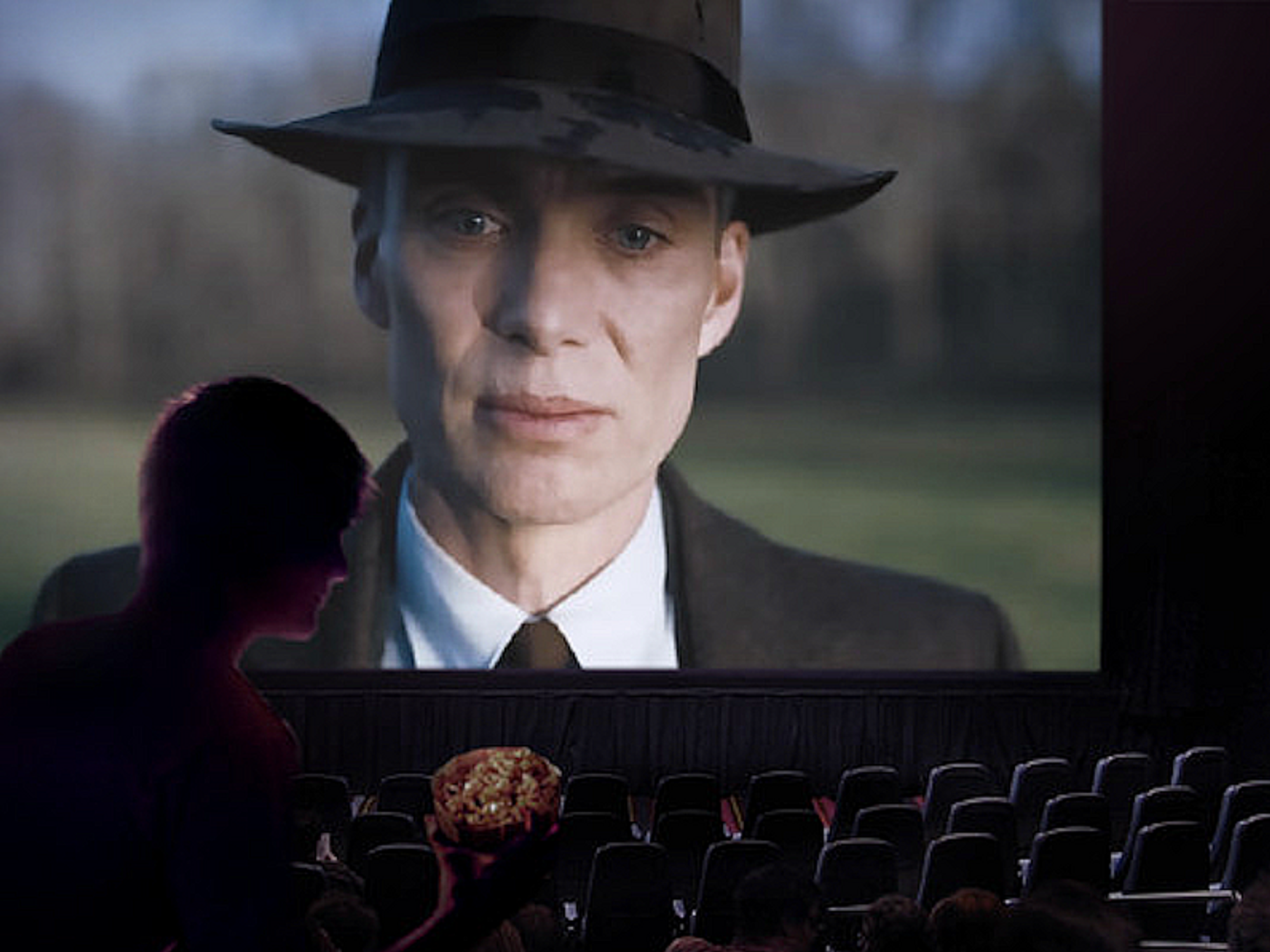 The movie Oppenheimer being projected on the screen at a cinema