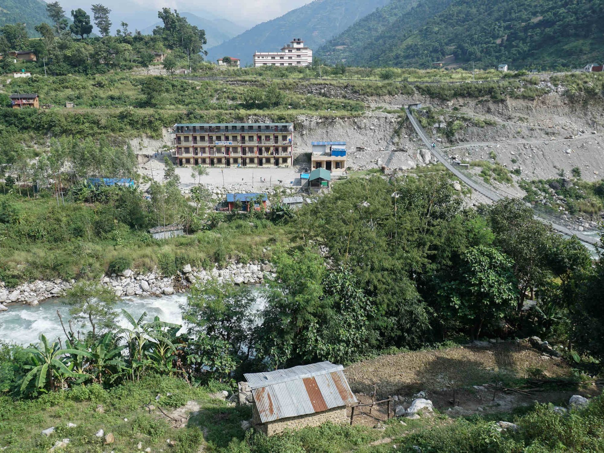 The office that coordinates work on the Nalgad hydroelectric power project is situated atop a hillside (white building) in the Nalgad municipality of Jajarkot district in Karnali province.