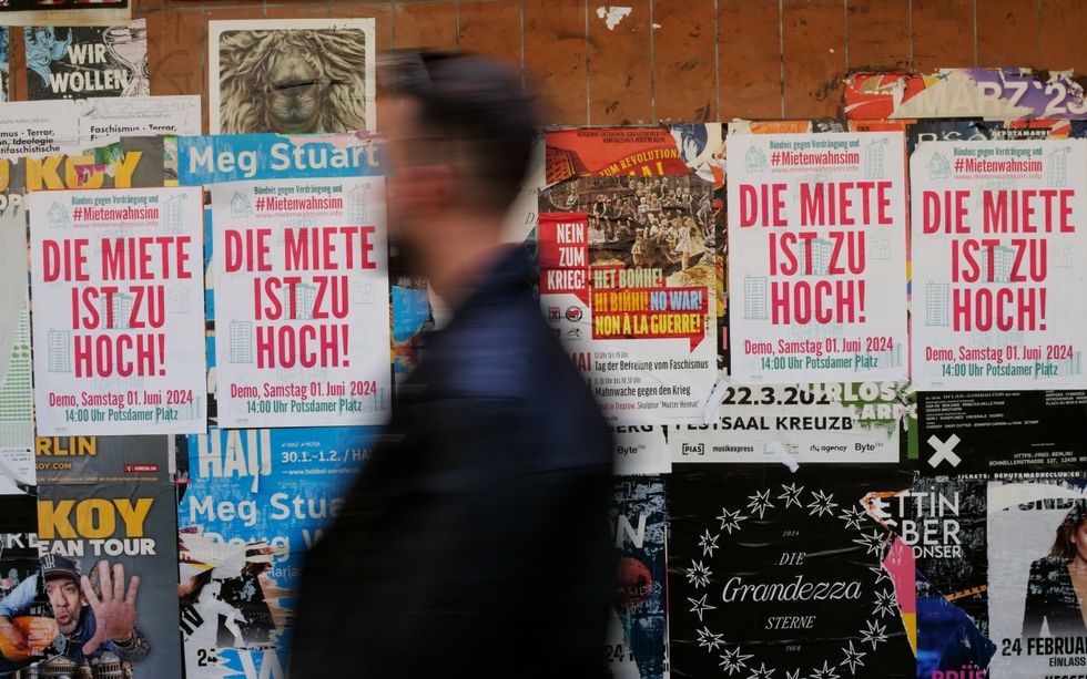 ''The rent is too high'' say posters on a wall in Berlin.