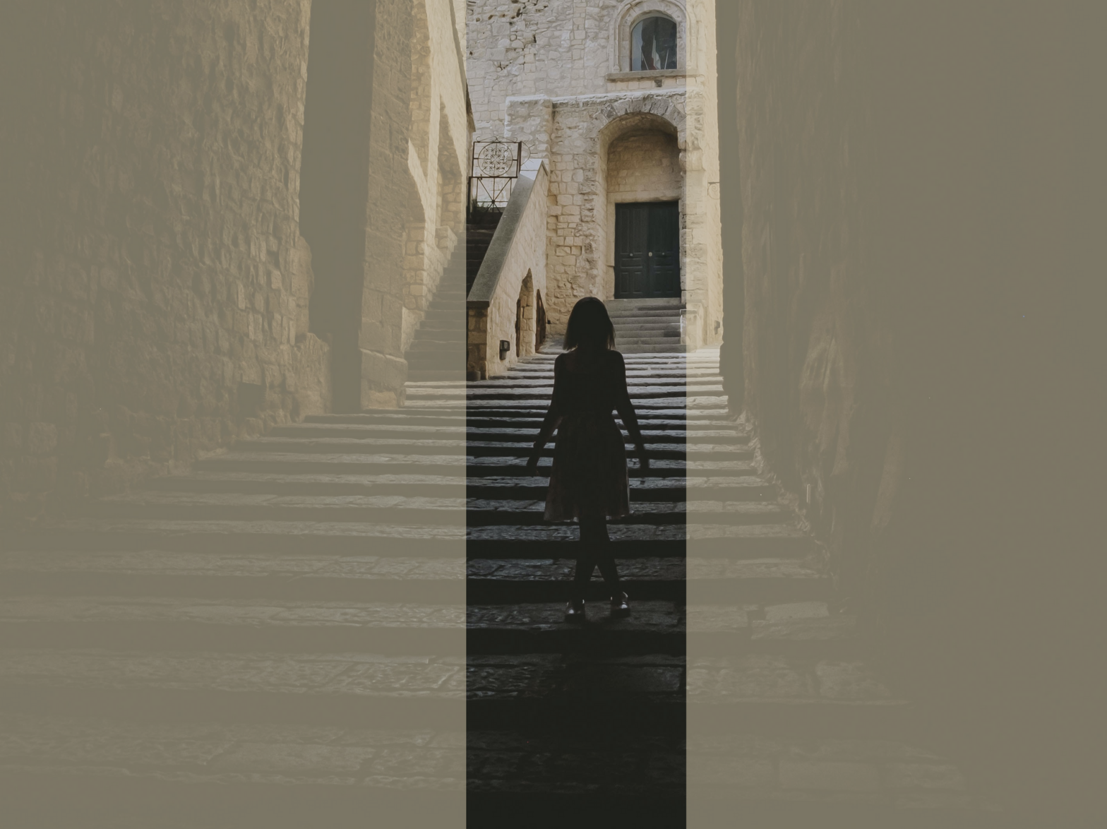 The silhouette of a little girl going down the stairs at a historical monument in Naples.