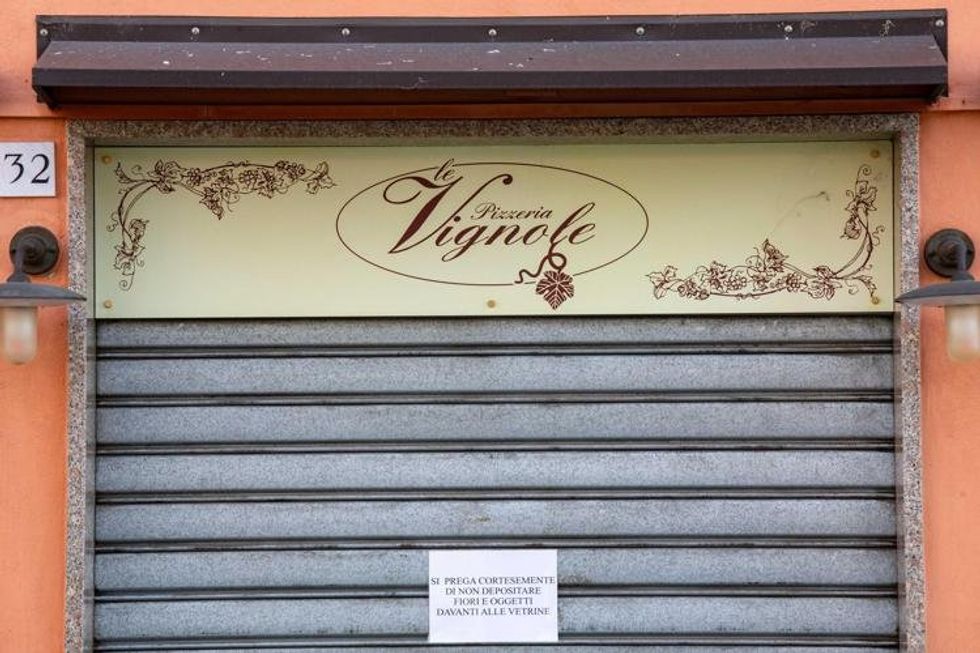 The store front of Le Vignole with the gate closed.