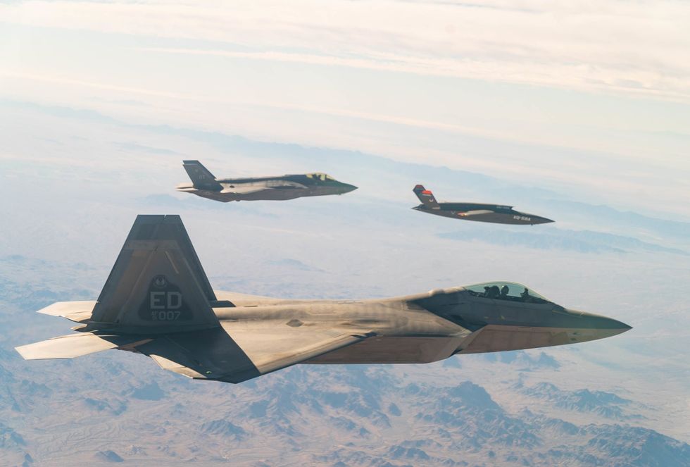 The XQ-58A Valkyrie flies in formation with two piloted U.S. Air Force planes during a test flight in December 2020.