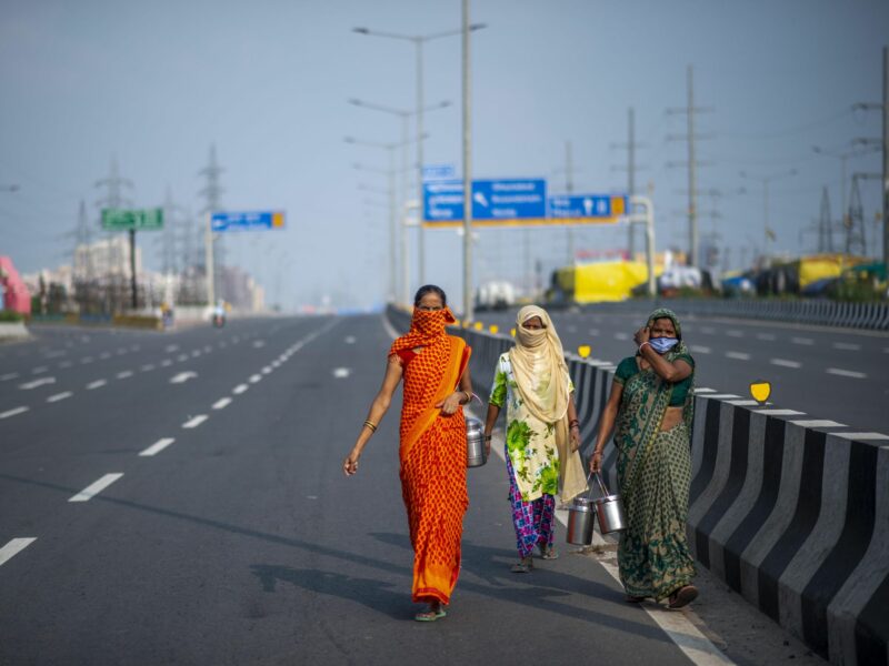 Three Indian women walk on a deserted road, Sep 27