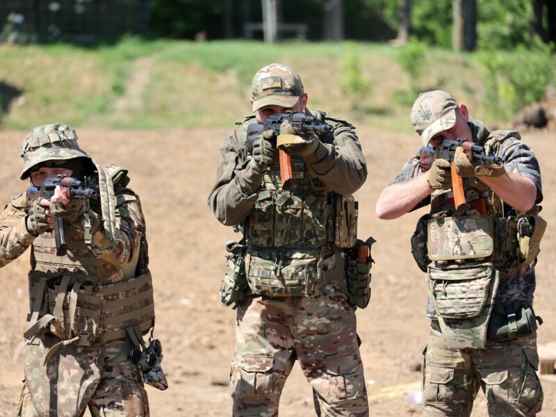 Three Ukrainian Servicemen aim their rifles towards the camera during training