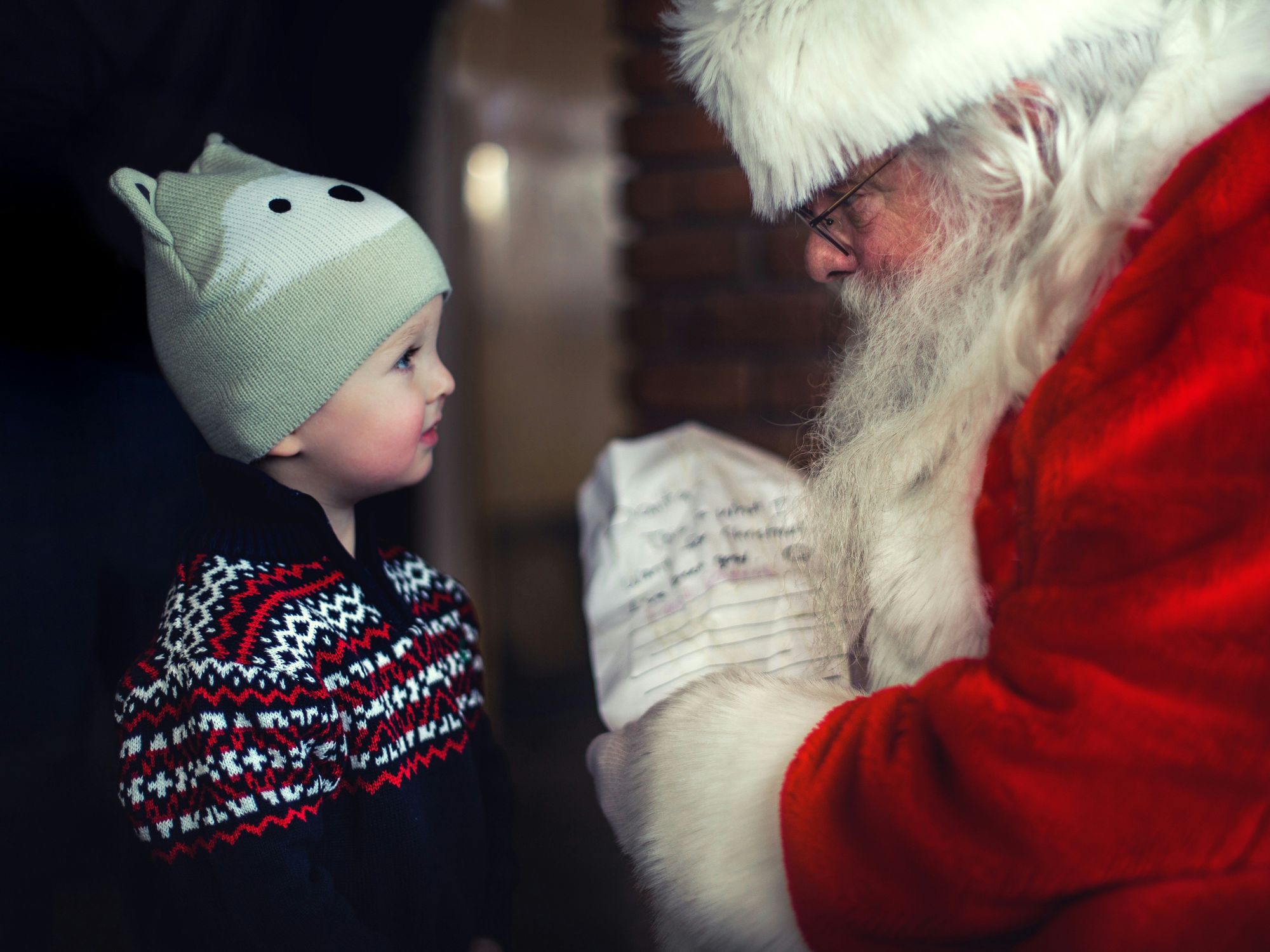 Toddler standing in front of Santa Claus, Oklahoma, United States, Dec. 11, 2016.