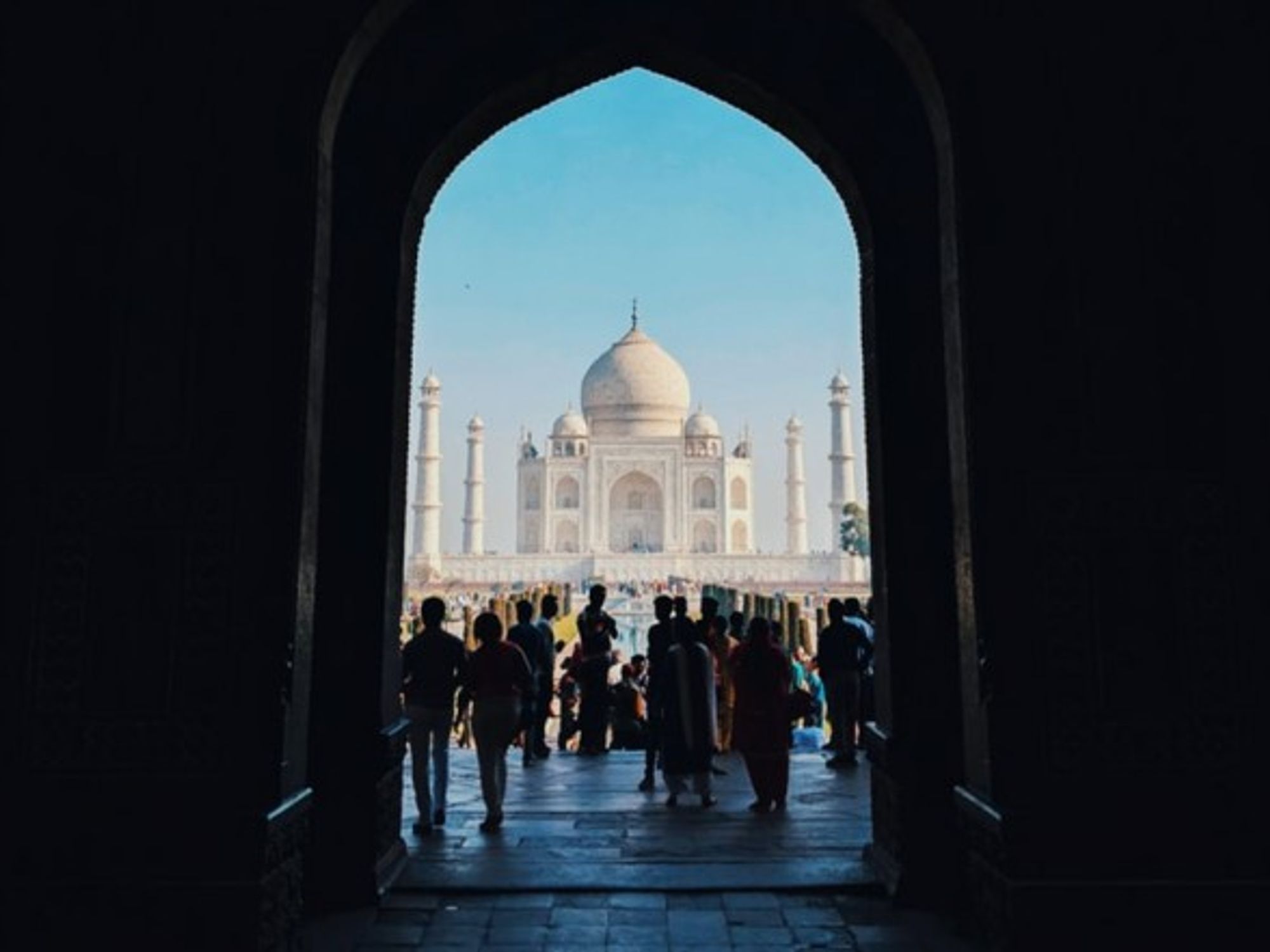 Tourists stand in front of the Taj Mahal in Agra, Uttar Pradesh, India.