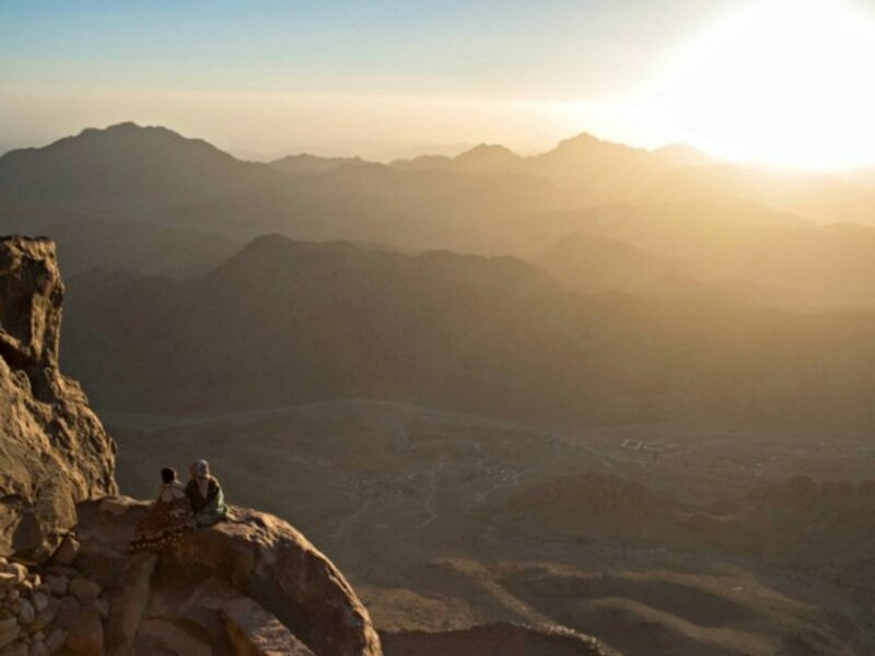 Tourists watch the sunrise on Mt. Sinai