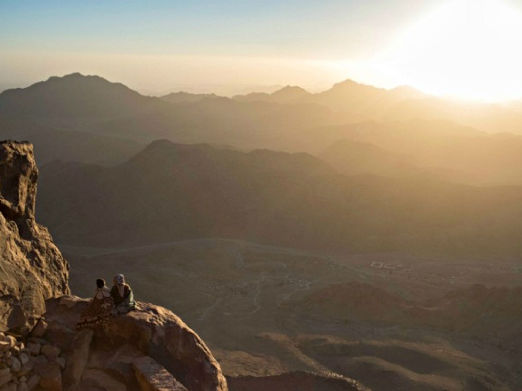Tourists watch the sunrise on Mt. Sinai
