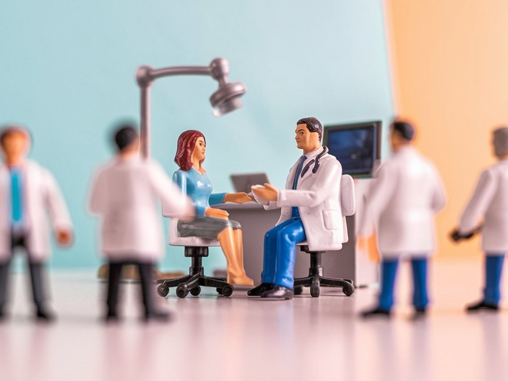 Toy figurines, doctors and one female patient