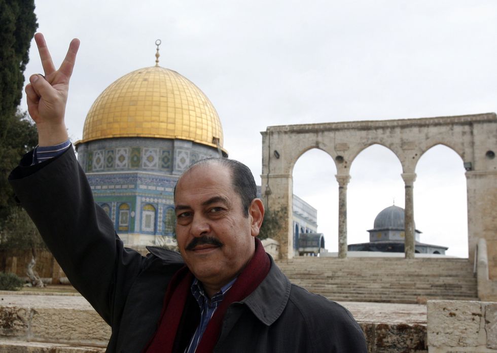 Tunesian artist Lotfi Bouchnak marks victory sign in front of the Dome of the Rock during a visit to the Al-Aqsa mosque compound, Islam's third holiest, in the old city of Jerusalem on November 12, 2012.