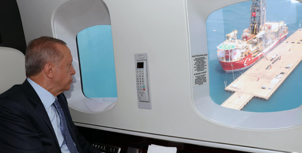Turkey's President Recep Tayyip Erdogan in his plane watching the ​"Abdülhamid Han" ship