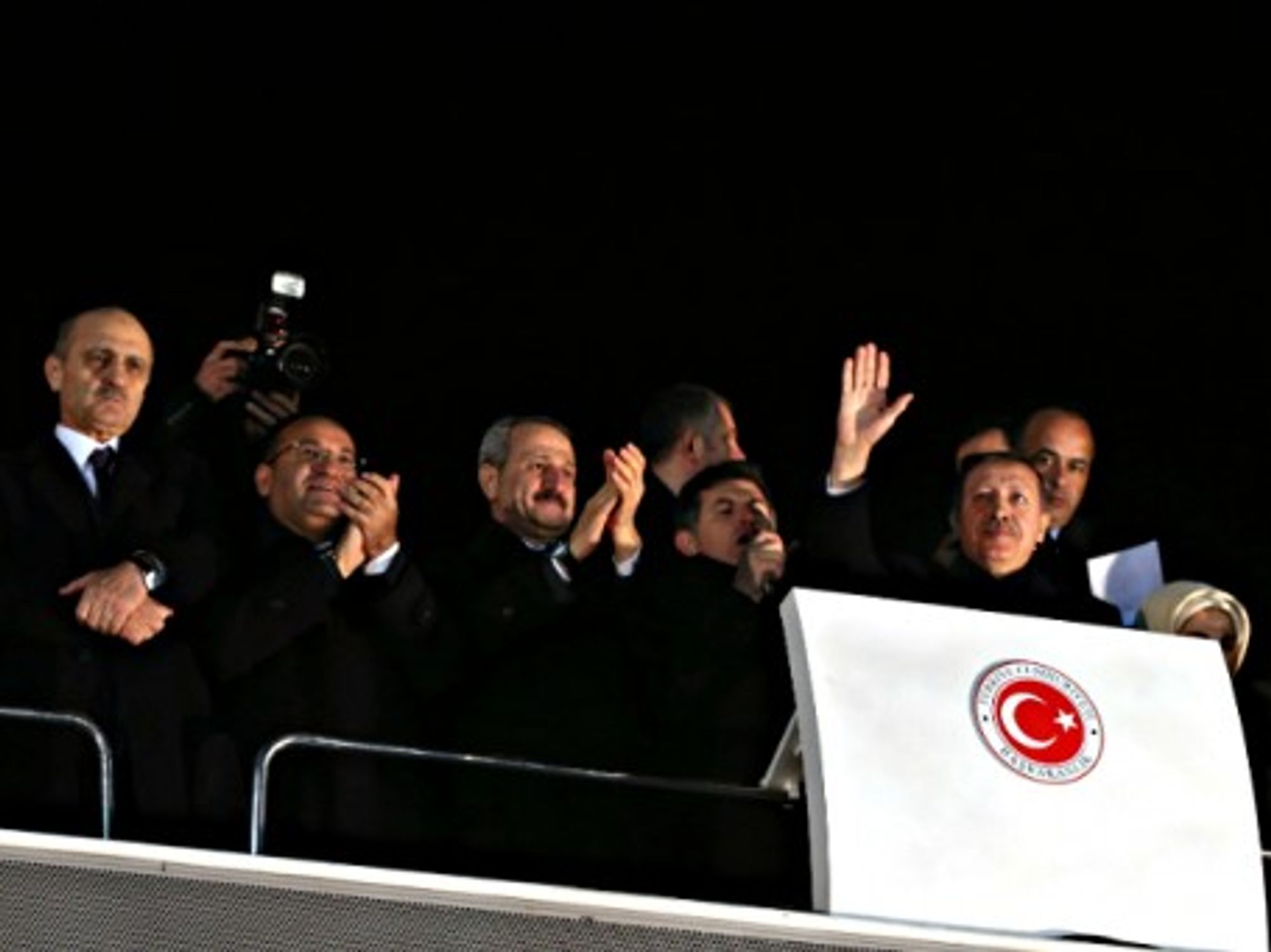 Turkish PM Recep Tayyip Erdogan (waving) and other AKP party members on Dec. 24