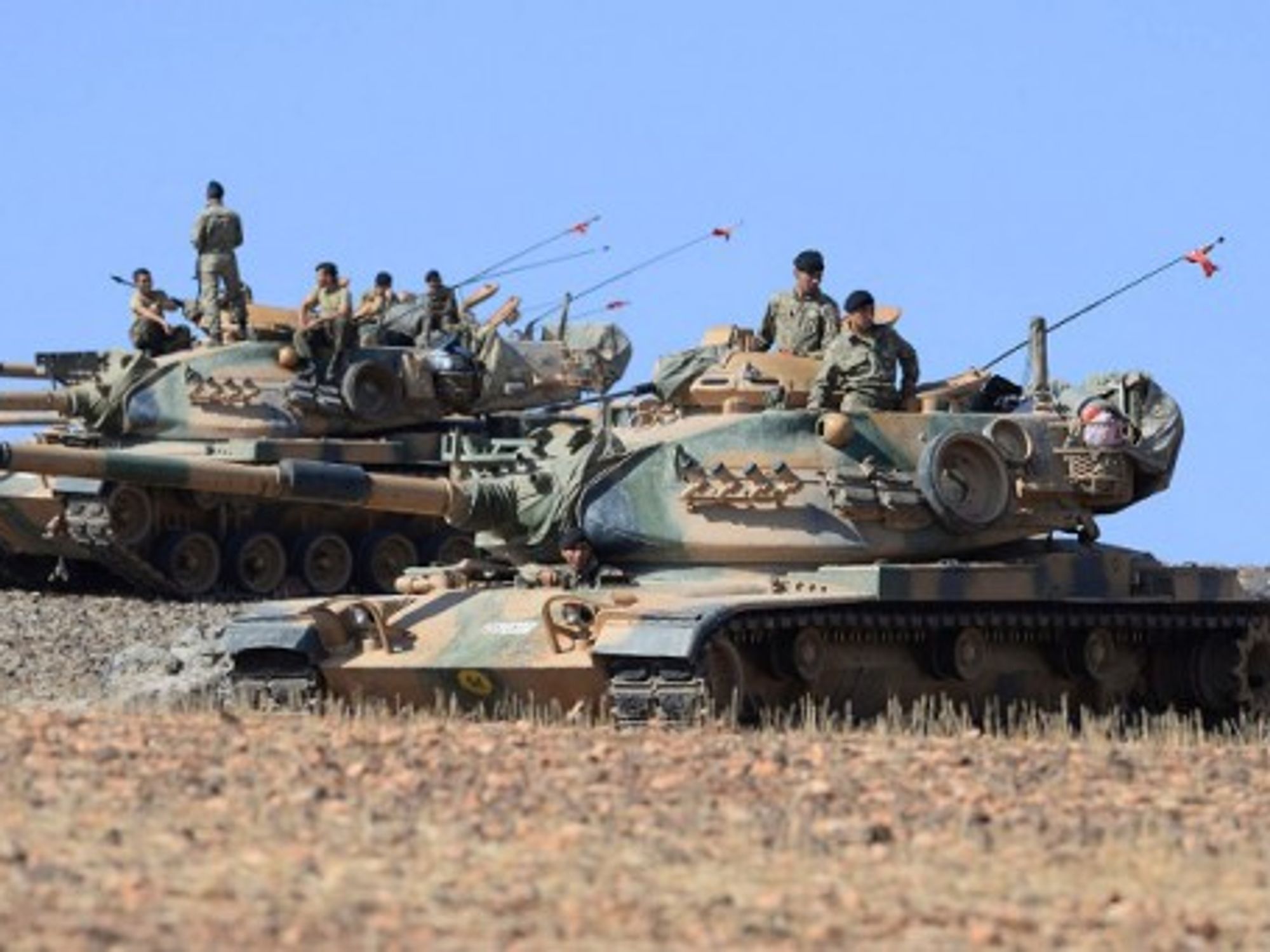 Turkish tanks take up position on the Turkish - Syrian border at Suruc, Turkey.