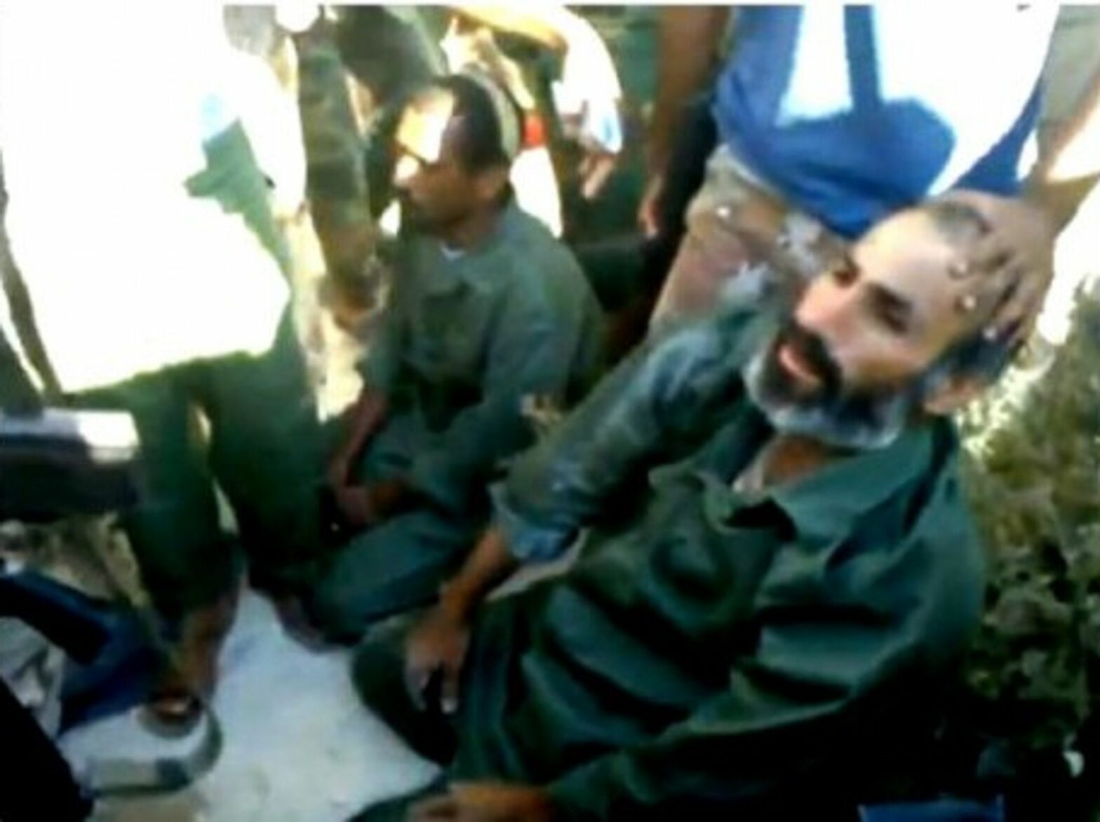 Two accused mercenaries being captured and questionned