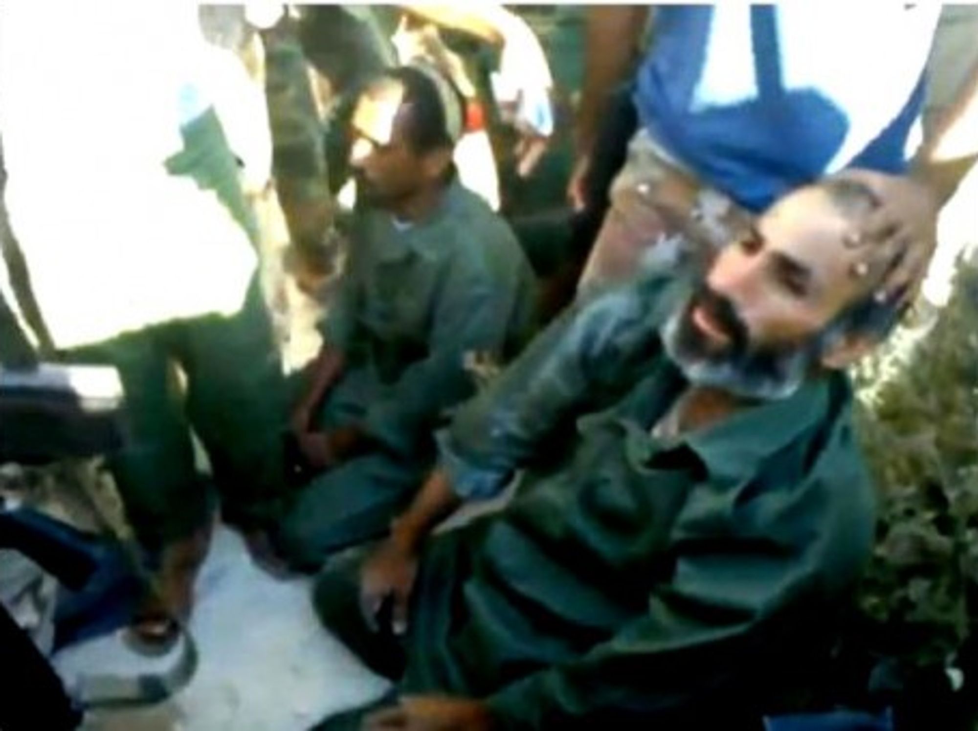 Two accused mercenaries being captured and questionned