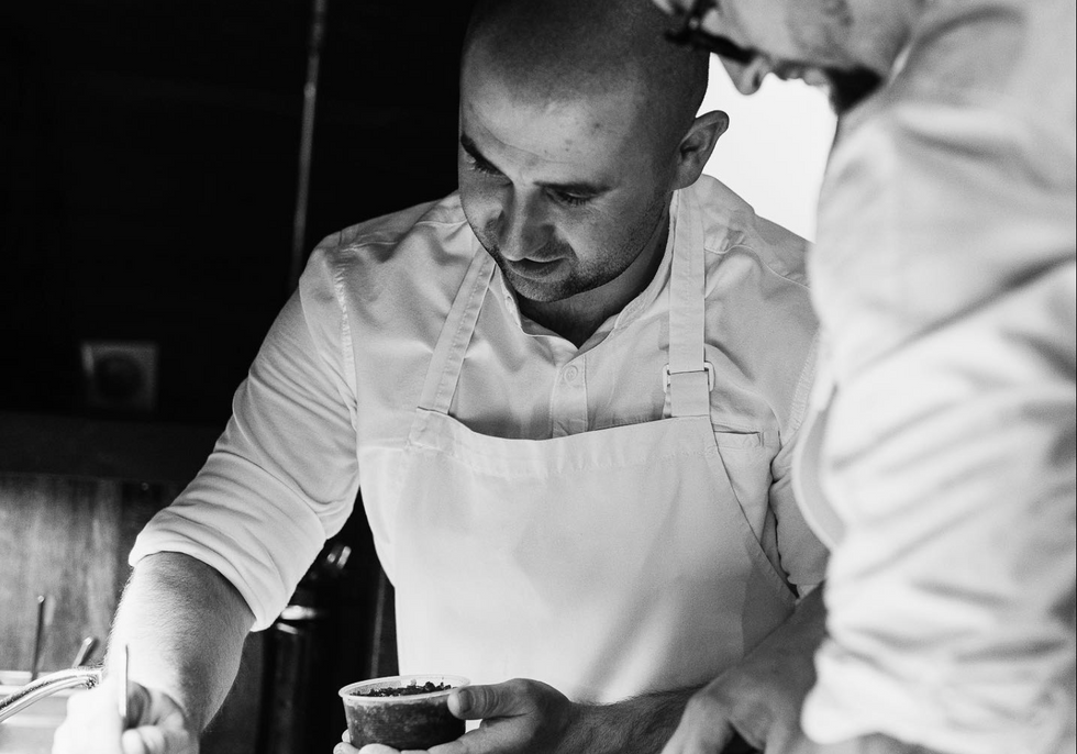 Two chefs preparing the restaurant's tasting menu.