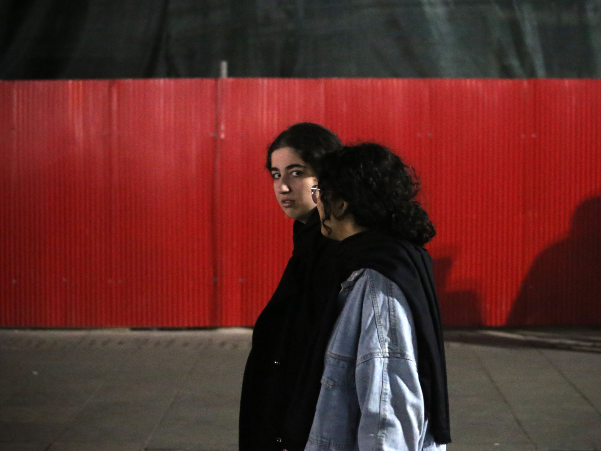 Two Iranian young women walk in Shahrdari Square in Rasht.