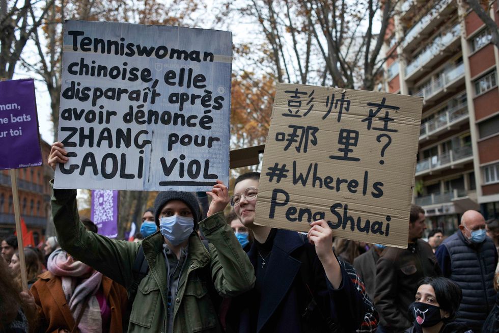 Two people hold placards for the Chinese tenniswoman Peng Shuai, Toulouse, France
