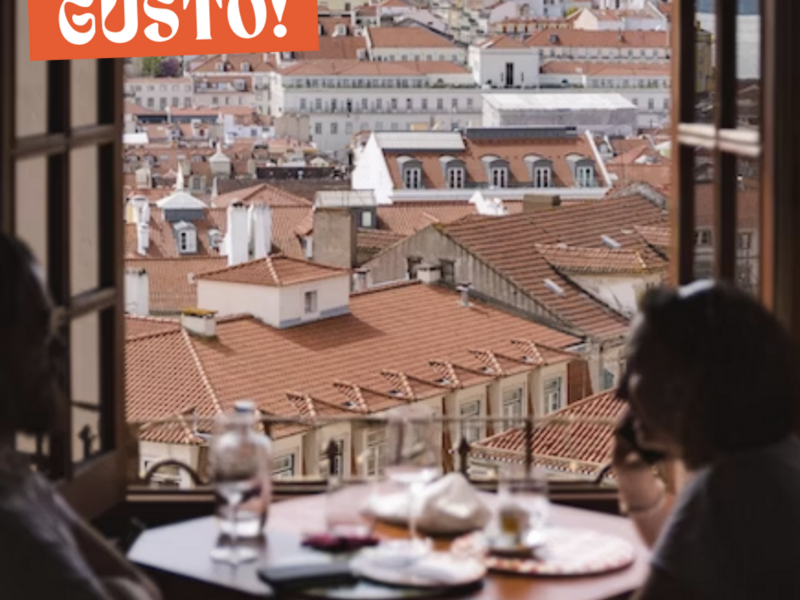 Two people sitting at a table in front of a window.