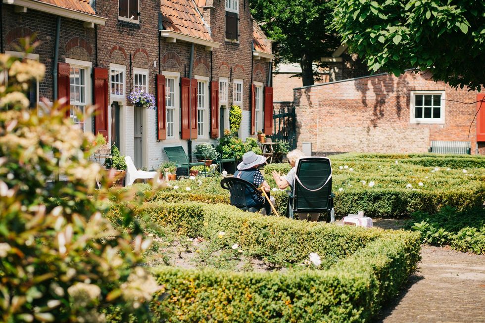 Two people sitting in a yard.