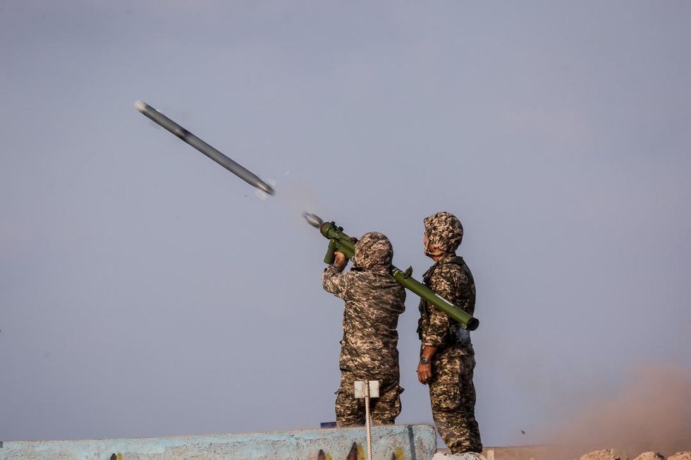 Two Revolutionary guards take part in military exercises.